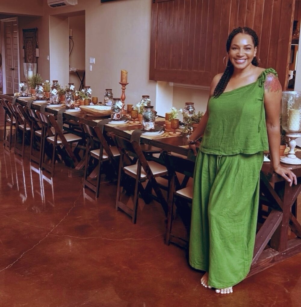 Hava founder standing beside the long table prepared for the founders retreat.