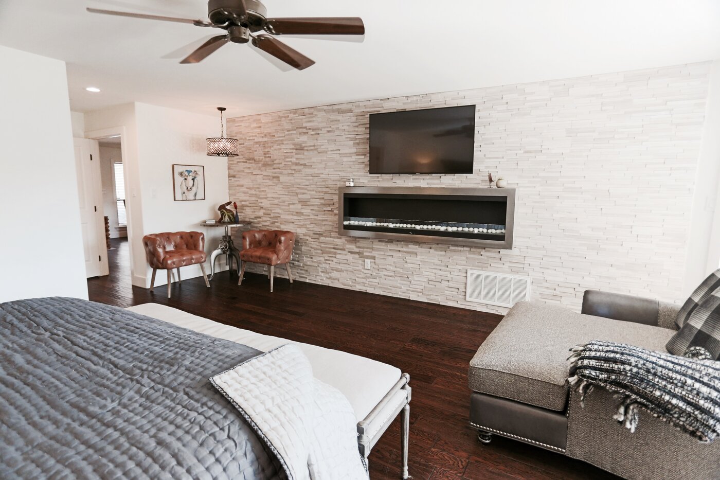 A large primary bedroom at Luna Rio with a king bed and a stone fireplace.