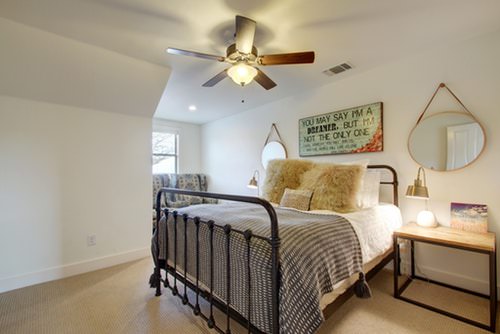 A private bedroom at Luna Rio with an iron-frame queen bed and a quiet corner.